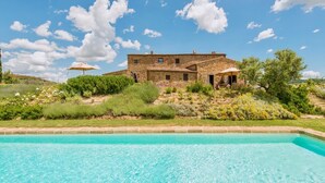 A stone house with a swimming pool in front. - VILLA MERAVIGLIOSA - Six Bedroom Villa, Sleeps 12 (Pienza)