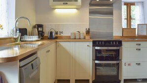 A modern kitchen with a dishwasher, oven, and a built-in microwave. - 1 bedroom accommodation in Swerford, near Chipping Norton (Swerford, near Chipping Norton)