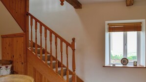 A wooden staircase leading to a landing with a window above. - Lakes, mountains or beaches - how about the best of all three. (Bigrigg, near Egremont)