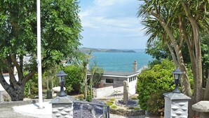 A coastal pathway with stone railings, a lamp post, and a view of the sea. - 1 bedroom accommodation in Mevagissey, near St Austell (Mevagissey, near St Austell)