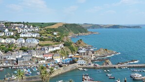 A coastal town with houses, a harbor with boats, and a view of the sea. - 1 bedroom accommodation in Mevagissey, near St Austell (Mevagissey, near St Austell)
