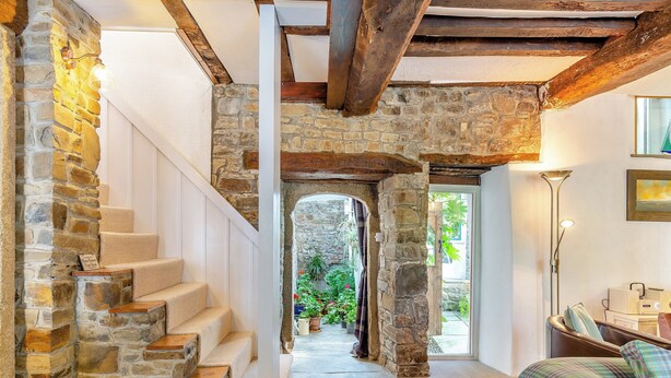 A stone staircase leading to a garden, a cozy seating area with a lamp, and a view of the outdoors. - 4 bedroom accommodation in Stratton, near Bude (Stratton, near Bude)
