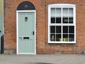 A light green door with the number 43 and a plaque above it.