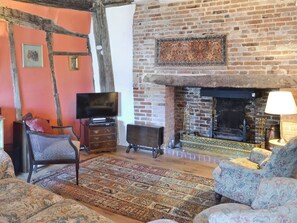 A cozy living room with a fireplace, a television, and comfortable seating.