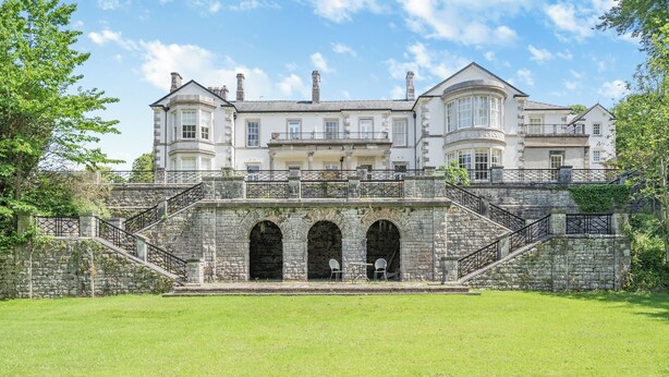 A large, historic building with multiple levels, stone staircases, and arched doorways. - Apartment 14, Hazelwood Hall (Silverdale, near Arnside)