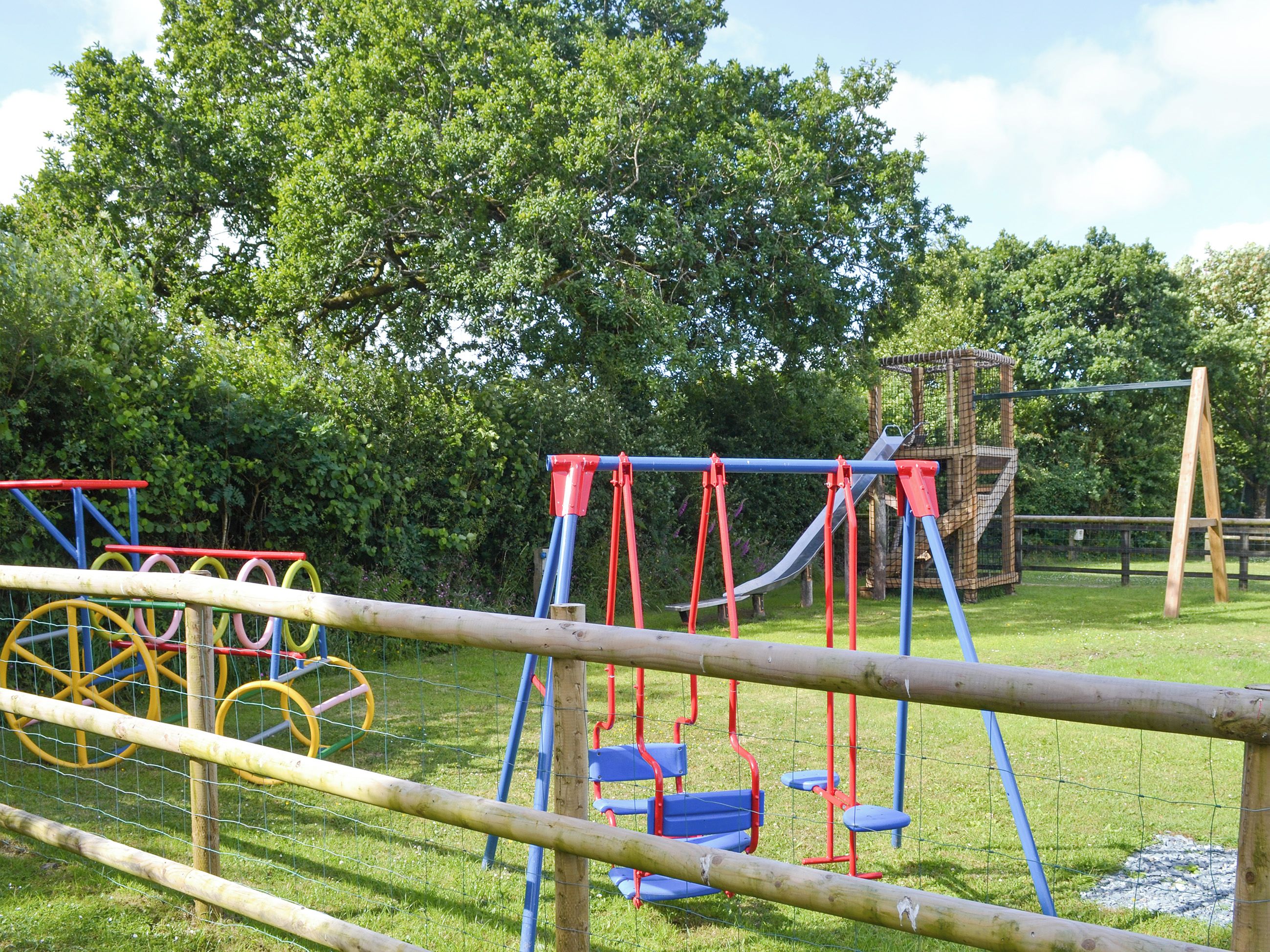A playground with swings, slides, and climbing structures.