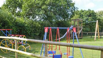 A playground with swings, slides, and climbing structures.