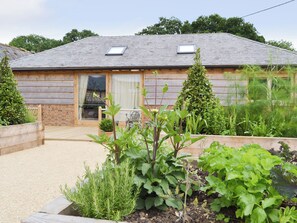 A wooden building with a sloped roof, a window, and a door.