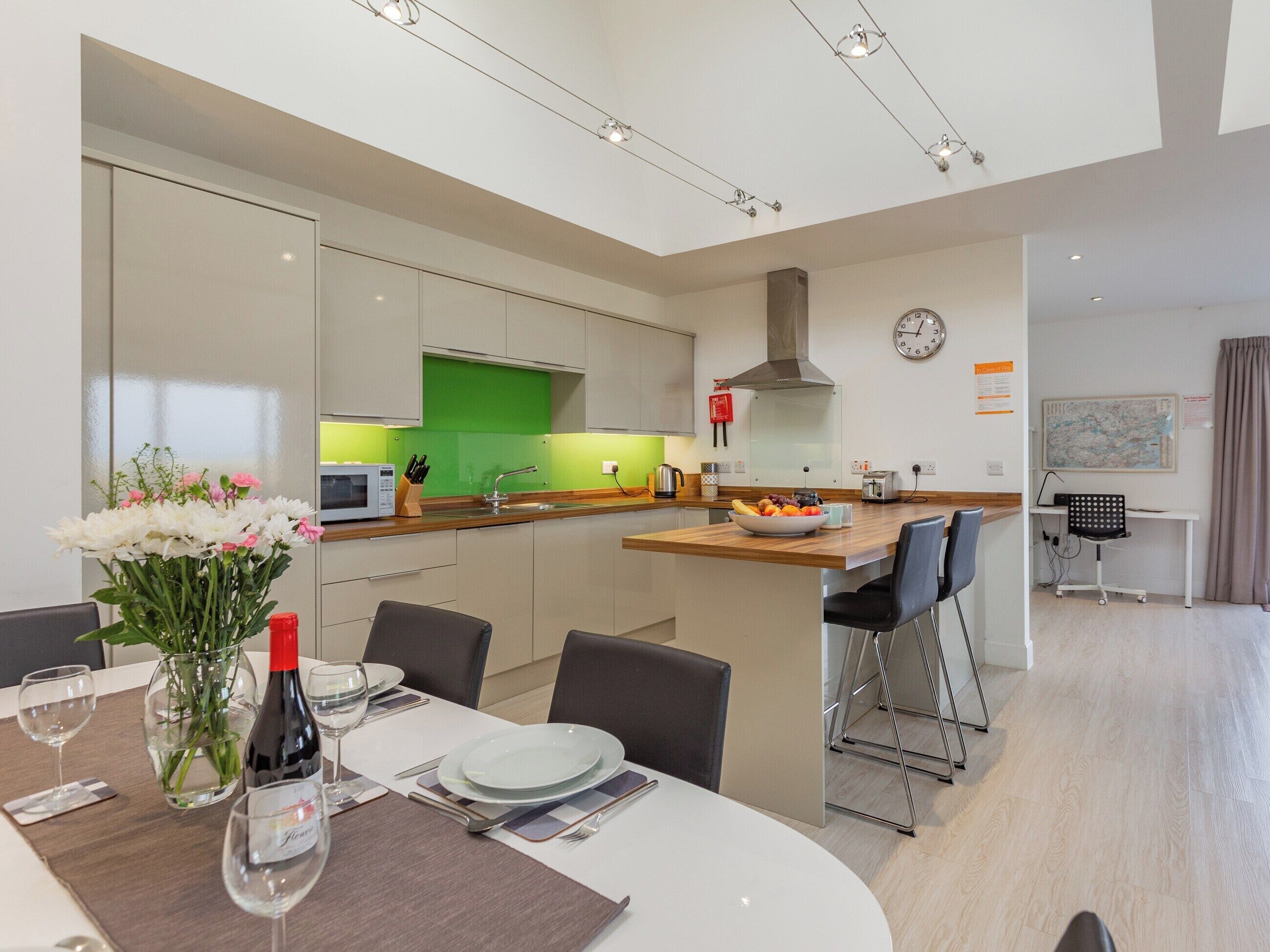 A modern kitchen with a dining area.
