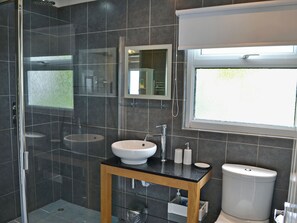 A modern bathroom with a glass shower enclosure, a white sink, and a toilet. - 2 bedroom accommodation in St Merryn, near Padstow (St Merryn, near Padstow)