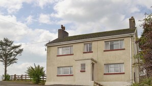 A two-story building with a flat roof and a chimney. - 3 bedroom accommodation in Cynheidre, near Llanelli (Cynheidre, near Llanelli)