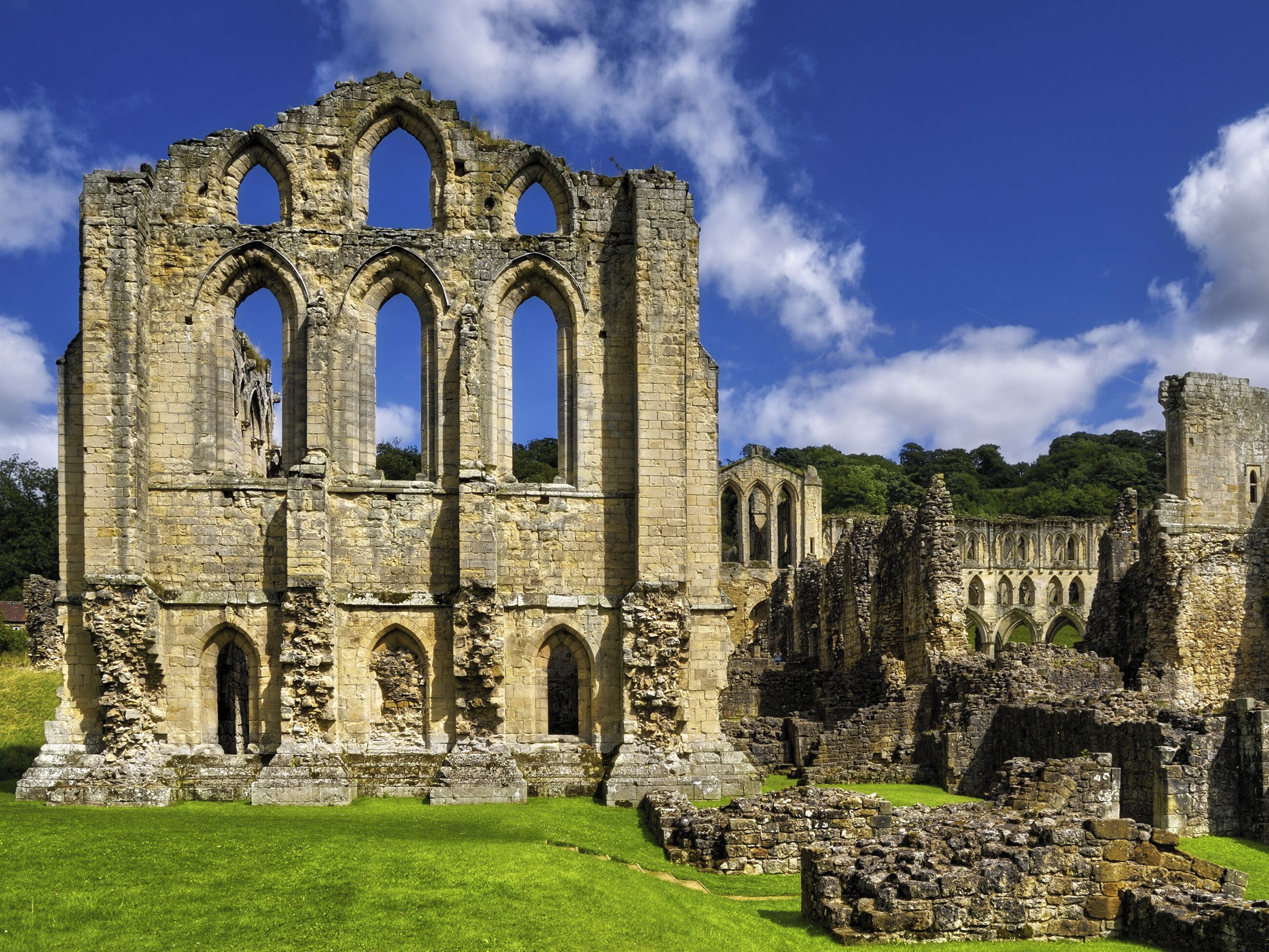 A historic stone structure with multiple arches and ruins.