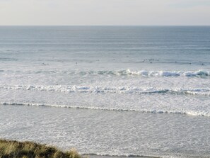 A coastal view with waves and a clear sky.
