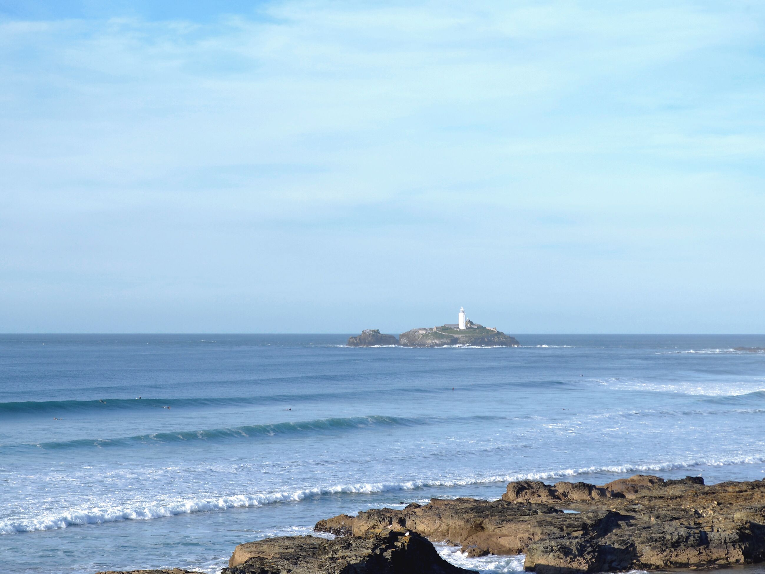A rocky shoreline with waves crashing onto the rocks.