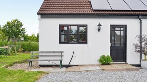 A single-story house with a tiled roof, a black door, and a window with a black frame. - 2 bedroom accommodation in Toynton-All-Saints, near Spilsby (Toynton-All-Saints, near Spilsby)