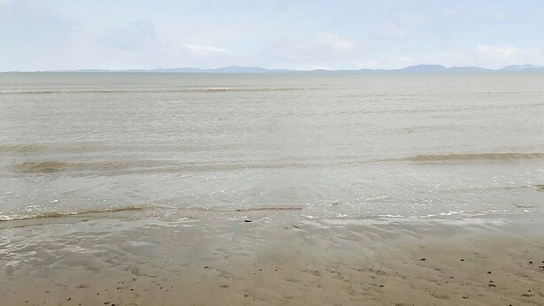 A beach with a wide expanse of sand and gentle waves. - 2 bedroom accommodation in Aspatria (Aspatria)