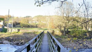 A wooden bridge over a river with a stone wall on one side and trees on the other. - 2 bedroom accommodation in St John&rsquo;s Chapel, near Stanhope (St John&rsquo;s Chapel, near Stanhope)