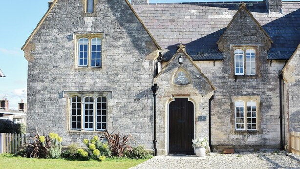 A stone building with multiple windows and a central entrance. - No. 1 The Old School (Puddletown, near Dorchester)