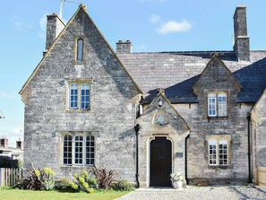 A stone building with multiple windows and a central entrance.