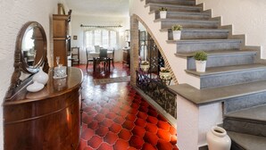 A staircase with a red patterned floor, a wooden side table with a mirror, and a vase. - Villa Mery, Holiday house in the hills of the Rimini Riviera, with private pool (Mondaino)