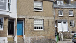A stone building with a blue door and white windows. - 3 bedroom accommodation in Penzance (Penzance)