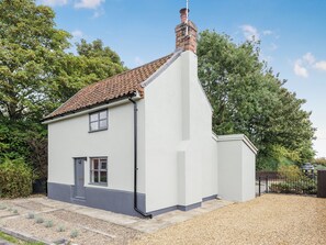 A single-story house with a sloped roof, a chimney, and a small front porch. - 2 bedroom accommodation in Blythburgh, near Southwold (Blythburgh, near Southwold)