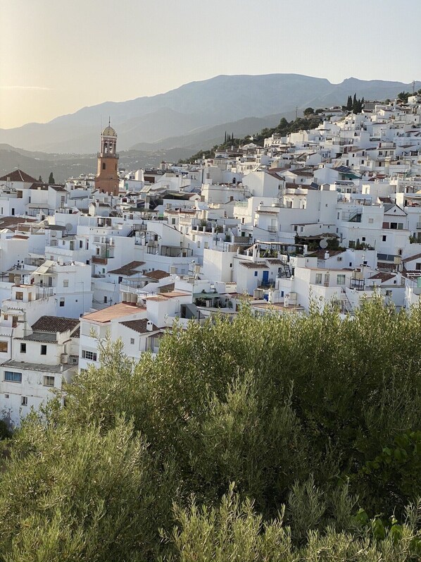 A densely packed town with white buildings and a prominent tower.