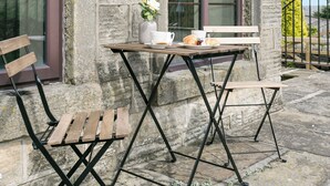 A stone building with a wooden table and metal chairs, a bench, and a vase with flowers. - 2 bedroom accommodation in Alton, near Chesterfield (Alton, near Chesterfield)