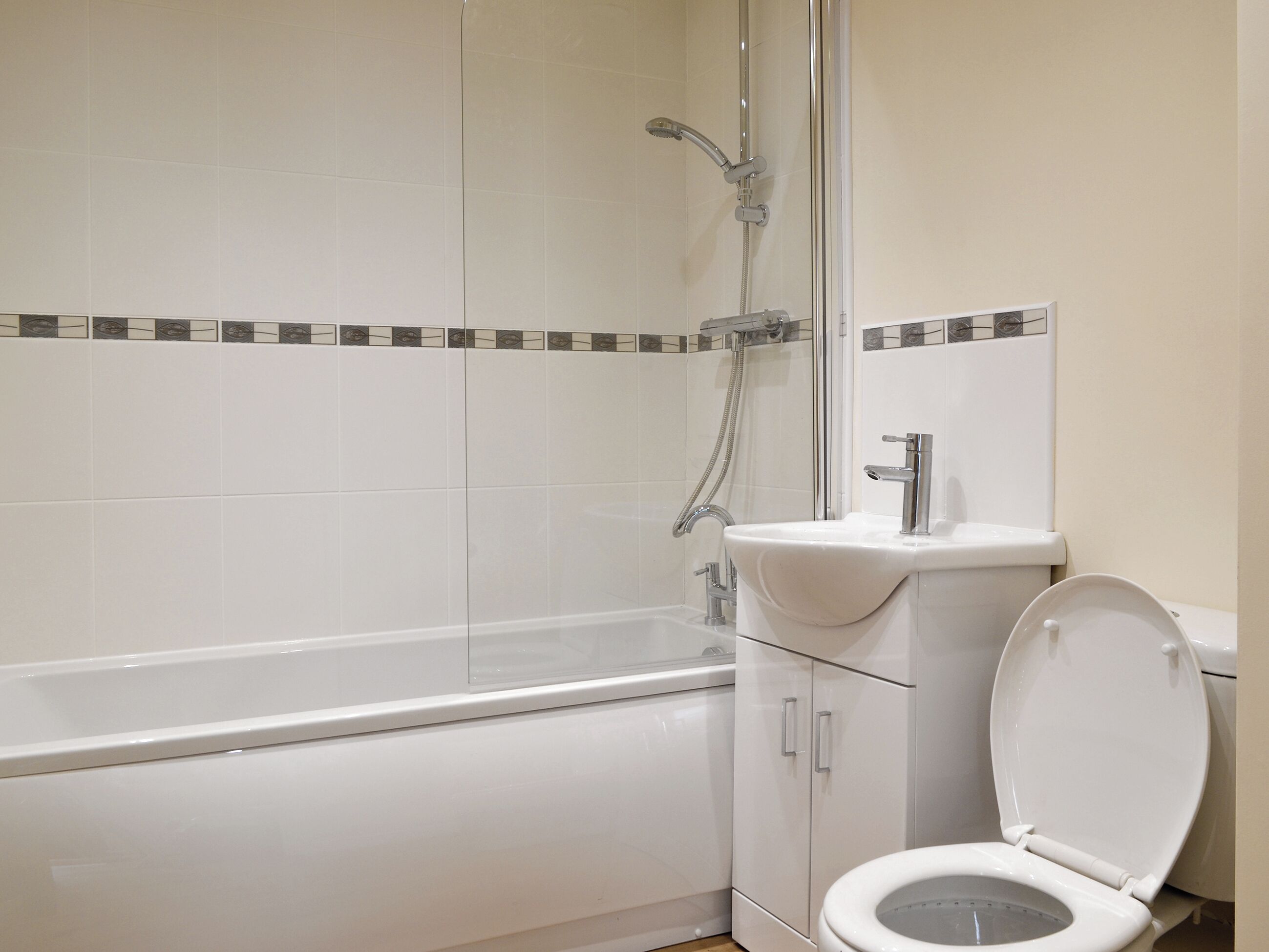 A bathroom with a bathtub, toilet, and shower.