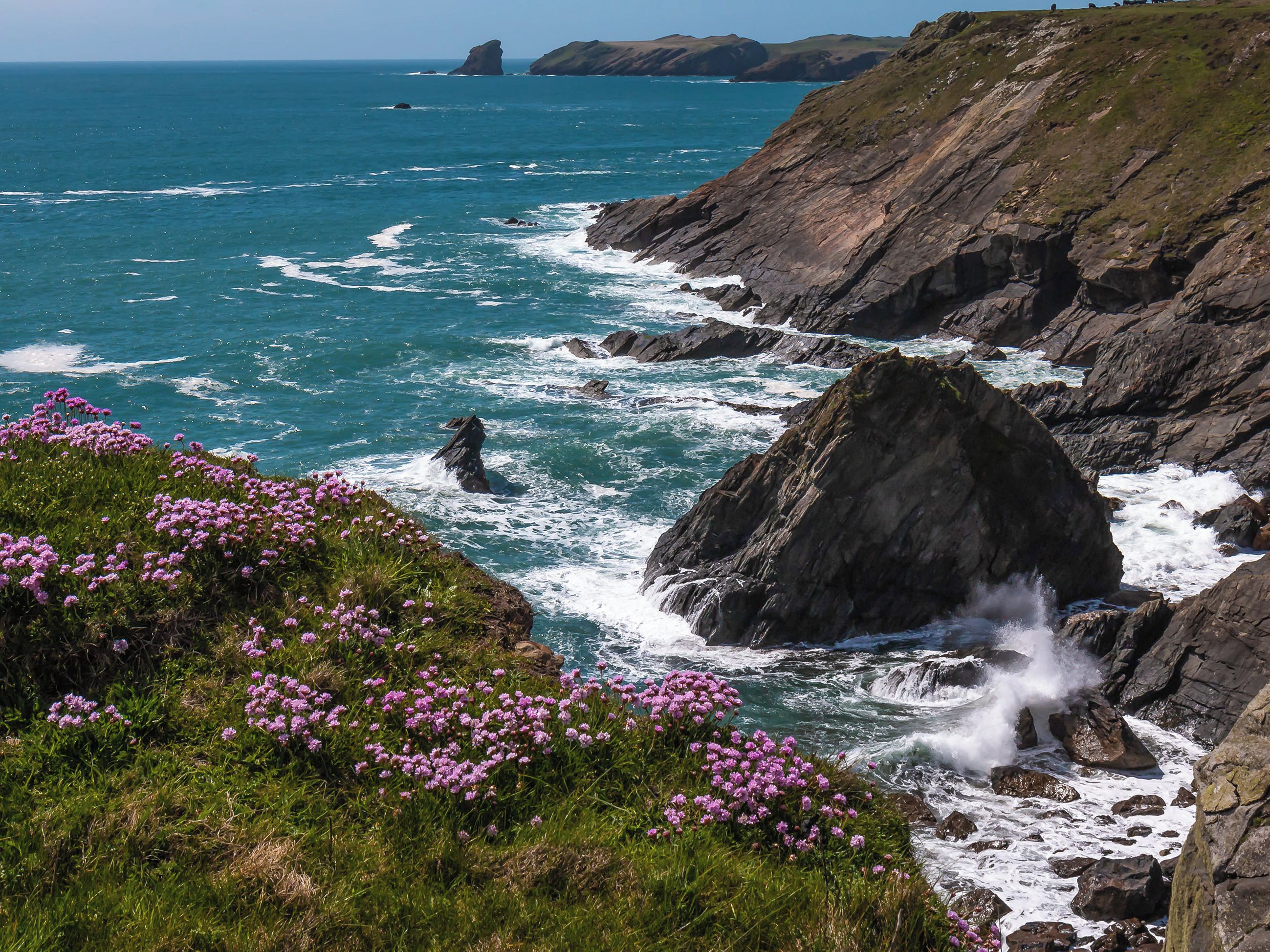 A coastal landscape with rocky terrain and a body of water.