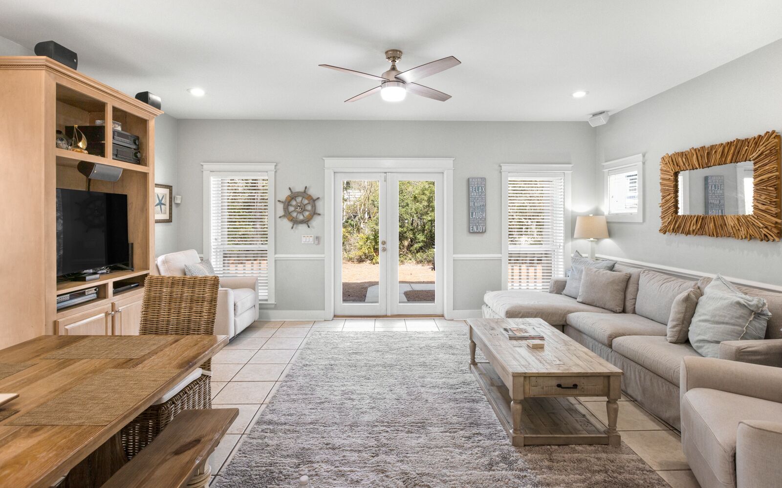 A living room with a television, sofa, coffee table, and a wooden cabinet.