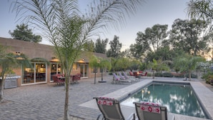 A poolside area with lounge chairs, a small pool, and a building with a glass door entrance. - STARFIRE Golf VIEW, Pvt POOL w/opt Heat, Putting Green, Fire Pit, 10 mins to Old Town (Scottsdale)