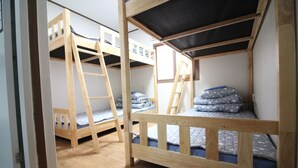 A dormitory room with bunk beds, wooden railings, and a ladder. - Friends of Loft - Hostel (Tongyeong)