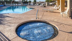 A swimming pool with a small hot tub, sun loungers, and a covered patio area. - One Story w/Htd Comm Pool & Spa: GOLF & Trails Nearby, Walk to Dine & Shop, Indoor Shuffleboard (Mesa)