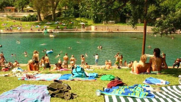 A pool area with people swimming and sunbathing. - Minutes to it all! Restaurants, Parks, Trails. Pet's Ok (Austin)