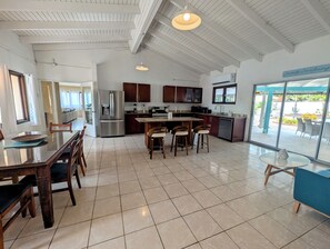 A spacious kitchen with a central island, stainless steel appliances, and a view of the outdoors. - Huge 5BR Villa, Private Pool & Swim-Up Bar. 15 min. Walk to Palm Beach & Casinos (Bakval)