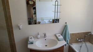 Bathtub, hair dryer, towels, soap