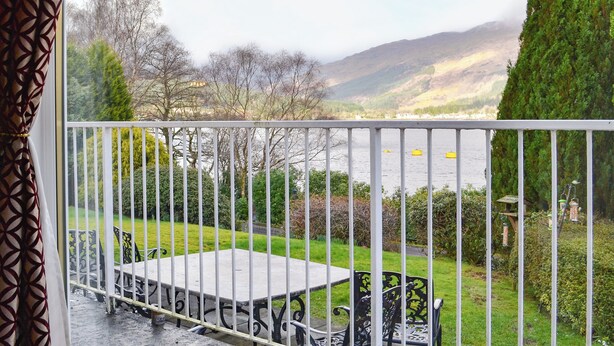 A balcony with a view of a lake and mountains. - 4 bedroom accommodation in Lochgoilhead, near Inverary (Lochgoilhead, near Inverary)