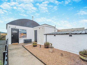 A building with a black door, a window, and a white exterior wall. - 1 bedroom accommodation in Bargrennan, near Glentrool (Bargrennan, near Glentrool)
