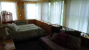 A room with two beds, a wooden headboard, a desk, and a window with curtains. - 5 Bedroom Pet Friendly House Lake George Region (Johnsburg)