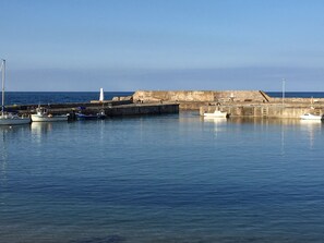 A harbor with boats docked at a stone pier. - 3 bedroom accommodation in Cullen (Cullen)