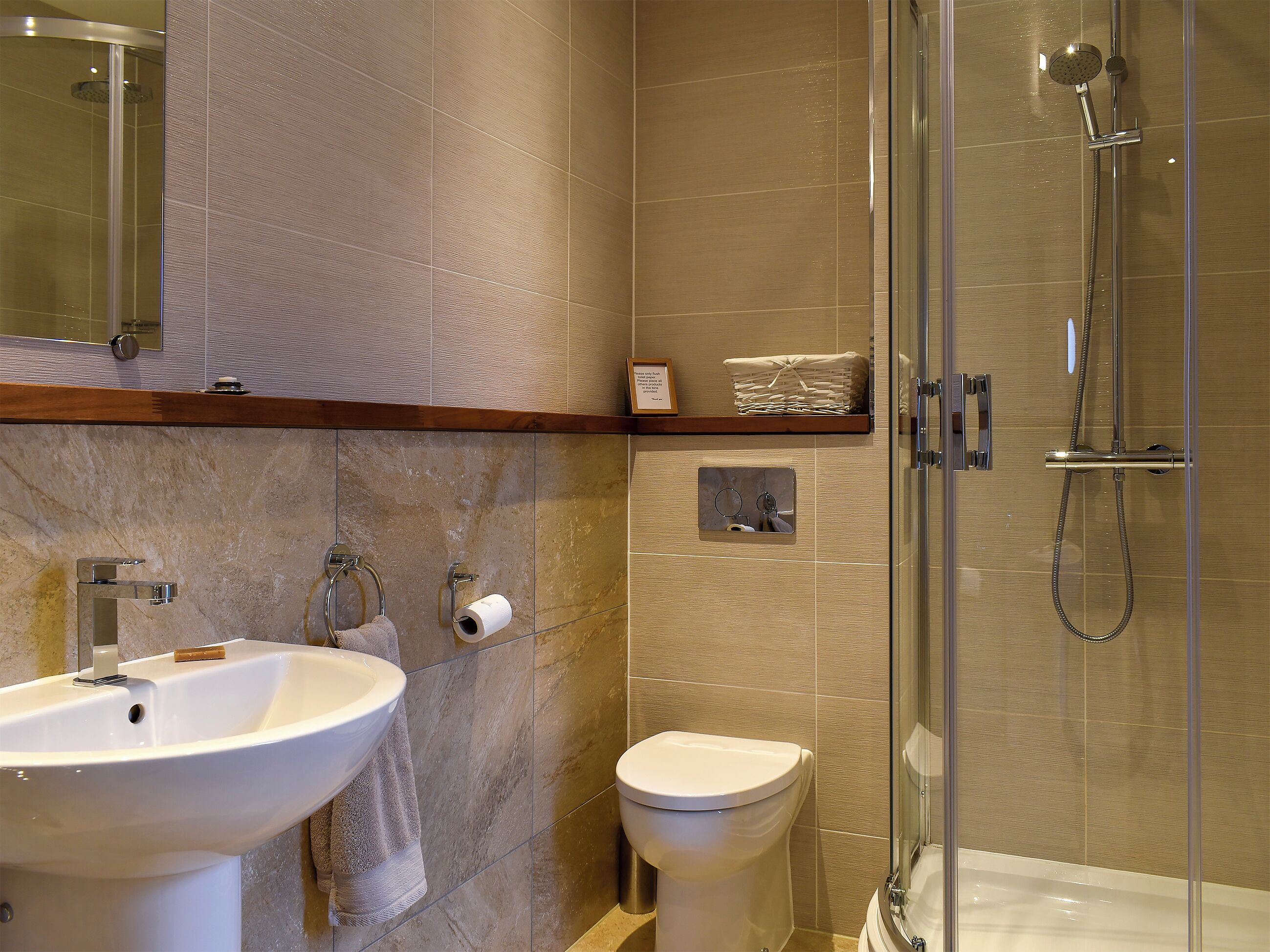 A bathroom with a sink, toilet, and shower.