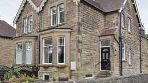 A stone building with a bay window, a black door, and a nameplate reading "EVERTON". - 3 bedroom accommodation in Bakewell (Bakewell)