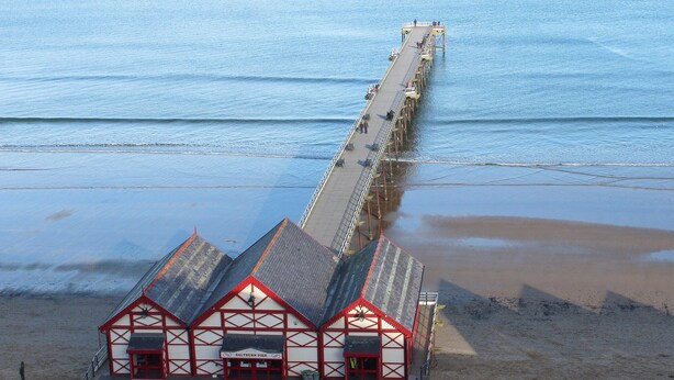 A pier extending into the sea with a building at the end featuring a red and white facade. - 2 bedroom accommodation in Loftus, near Saltburn-by-the-Sea (Loftus, near Saltburn-by-the-Sea)
