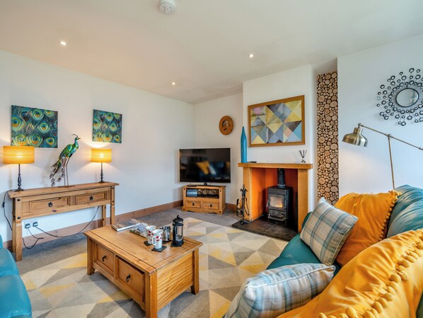A living room with a fireplace, a television, and a sofa.