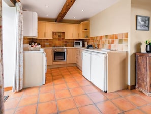 A compact kitchen with a gas stove, oven, microwave, and a dishwasher. - 2 bedroom accommodation in Catfield (Catfield)