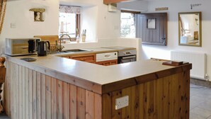 A kitchen with a wooden island, a sink, and a window with a view of the outside. - 3 bedroom accommodation in Thornton Rust, near Leyburn (Thornton Rust, near Leyburn)