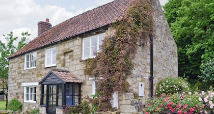 A detached character cottage with an open fire, overlooking Rievaulx Abbey.