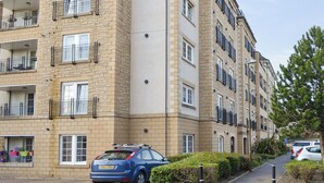 A multi-story residential building with balconies and a parking area. - 3 bedroom accommodation in Edinburgh (Edinburgh)
