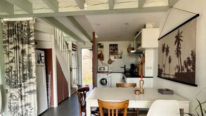 Una cocina moderna con comedor, que incluye una mesa grande, sillas y una isla de cocina.